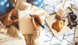 ペンと持ってノートに書き込もうとする女性の手
