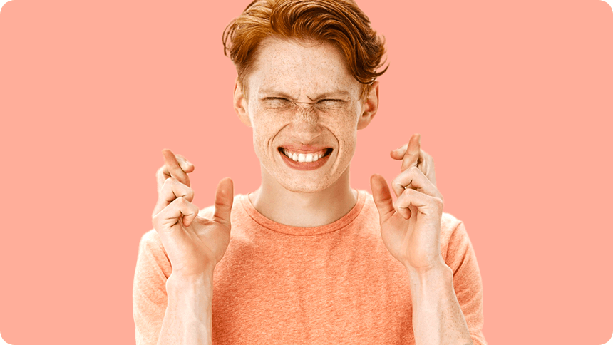 おどけた表情で「冗談」を意味するハンドサインをする男性